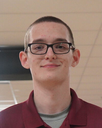 Photo of Janzen Kindlespire - Male smiling wearing a garnet FSU polo shirt with FSU logo