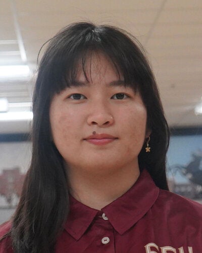Photo of Han Ly - Female smiling wearing a garnet FSU polo shirt with FSU logo