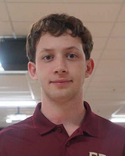Photo of Liam Pasch - Male smiling wearing a garnet FSU polo shirt with FSU logo