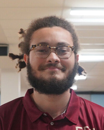Photo of Tyrel Rice - Male smiling wearing a garnet FSU polo shirt with FSU logo