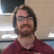 Photo of Bryan Blatt - Male smiling wearing a garnet FSU polo shirt with FSU logo