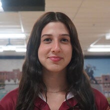 Photo of Caroline Geller - Female smiling wearing a garnet FSU polo shirt with FSU logo