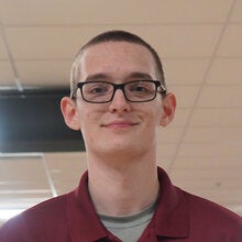 Photo of Janzen Kindlespire - Male smiling wearing a garnet FSU polo shirt with FSU logo