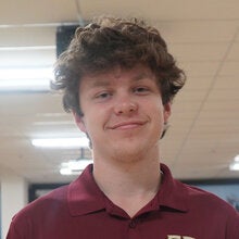 Photo of Seamus Murray - Male smiling wearing a garnet FSU polo shirt with FSU logo