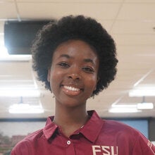Photo of Noraly Paul - Female smiling wearing a garnet FSU polo shirt with FSU logo