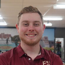 Photo of Cade Rogers - Male smiling wearing a garnet FSU polo shirt with FSU logo